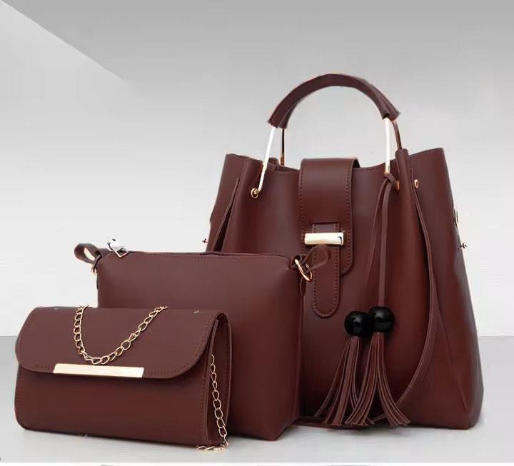 Set of three brown handbags with gold accents on a light gray background