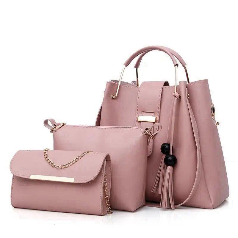 Set of three pink handbags with gold accents on a white background